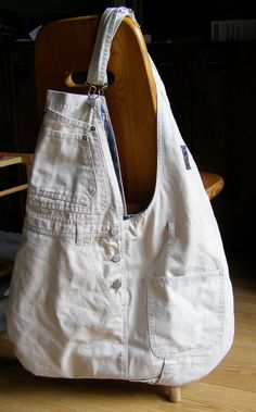 a white purse sitting on top of a wooden chair