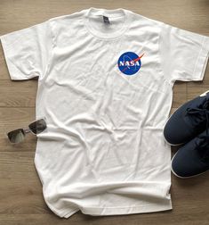 NASA Meatball Insignia logo T-Shirt. These tees have the small Meatball Logo on the left portion of the chest. Available in White, contact us a size chart if needed. We also carry Hoodies, Sweatshirts, long sleeves, toddler and baby sizes too! Each item is designed and printed in the Portland with high quality workmanship. These NASA Meatball Insignia Tees are 100% air-lume combed, ring-spun cotton, fashion tees that are super soft and comfortable. They're a fashion fit with a slightly higher ar Baby Size, Space Tee, All Colors, Nasa Shirt, Fashion Tees, Cotton Fashion, Tshirt Logo, Color Swatch, Fashion Fits