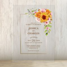 a wedding card with sunflowers and flowers on it, in front of a wooden background