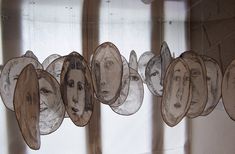 some paper faces are hanging on the wall