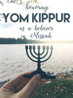 a hand holding a menorah with the words, how doing yom kippur as a believer in messiah