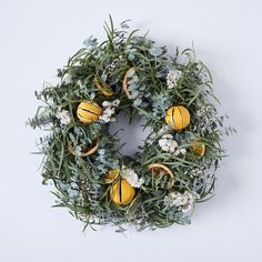 a wreath with oranges and flowers on it