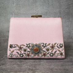 Intricately handmade design of Soft Pink Embroidered Clutch Purse with Pearl Chain made with soft silk fabric and comes with the heavy embellishment of floral embroidery pattern made with metallic threads and precious gemstones like onyx beads, sand stones, tigers eye, and pearls. This unique and stylish zardosi clutch purse can be a perfect gift for your female loved one. It's a must-have party clutch that will go best with almost any of your favorite outfits. This beautiful zardosi handbag is made over an imported metallic frame and wrapped with silk fabric. The interior of this handcrafted clutch purse is made with satin fabric and it has enough room for your essentials. This Pink Clutch comes with a carry chain of pearls. Size cm :20x15x6 Utility: Shoulder Bag Material: Silk Fabric, Me Festive Hand Embellished Rectangular Bag, Festive Embellished Evening Clutch Bag, Traditional Embellished Bags For Events, Luxury Handmade Bags For Reception, Luxury Embellished Evening Bag For Reception, Elegant Embellished Evening Bag For Festive Occasions, Elegant Pink Evening Bag For Festive Occasions, Hand Embellished Bags For Reception, Festive Luxury Evening Bag With Pearl Embroidery