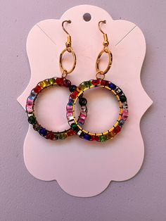 Introducing our Vibrant Glass Bead Circle Earrings, a lively burst of color and sparkle perfect for any occasion! These unique earrings are handmade with precision, using an array of colorful glass beads arranged in a stunning circle design. Please note that each of our items is handmade with love and care. As such, the product you receive may not look exactly like the picture. Minor variations in color, shape, and size are to be expected and add to the unique, one-of-a-kind nature of each piece Rainbow Glass, Circle Design, Circle Earrings, Unique Earrings, Glass Bead, Colored Glass, Jewelry Earrings Dangle, With Love, Etsy Earrings