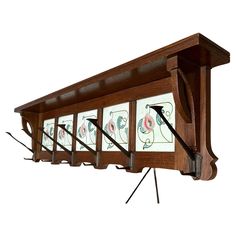 a wooden shelf with four glass panels hanging from it's sides