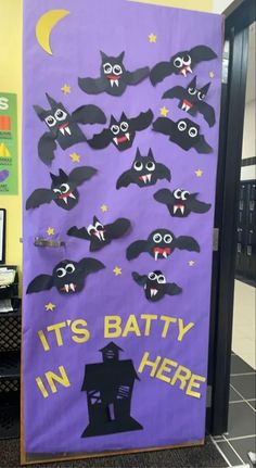 a bulletin board decorated with bats and words that say it's batty in here