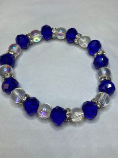 Glass Stretch Bracelet. Blue Glass Beads are 10 MM and Translucent beads are 8MM. The size of this bracelet is around 7.5 inches. If you need larger or smaller, please message me. Measure the circumference of your wrist and add 1/2 inch to get the correct size. To return to my homepage, click the below: https://www.etsy.com/shop/AllisonsJewels Holiday Beaded Jewelry, Willoughby Ohio, Clear Bracelet, Expensive Jewelry Luxury, Diy Jewelry Unique, Bracelet Wedding, Beads Bracelet Design, Bracelets Diy, Jewelry Techniques