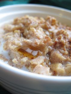 a white bowl filled with oatmeal sitting on top of a green cloth