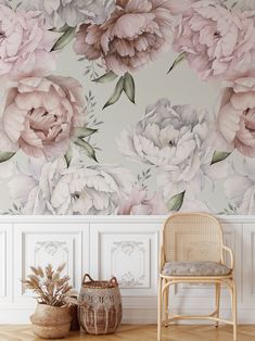 a wall with flowers painted on it next to a chair