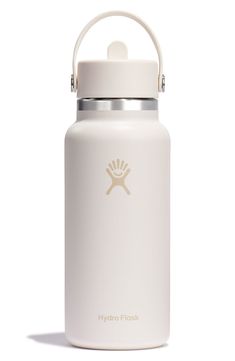 the hydro flask water bottle is white and has a gold logo on it