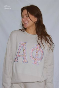 sorority merch crewneck bella soft valentine galentine alpha phi sorority plaid applique stitched letters cream floral Monogrammed Sweatshirt, Embroidery Items To Sell, Sorority Style Spring Sweatshirt With Letter Print, Letter Shirts Sorority, Patchwork Crewneck, Letters Sorority Sweatshirt, Sorority Letter Print Sweatshirt In Relaxed Fit, Spring Sorority Sweatshirt With Letter Print, Stitch Letters Sorority