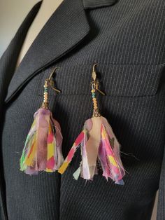 These earrings are made with fine colored silk ribbons fixed in a small chiseled bell, like pompoms. I added pink seed beads * Silk chiffon, painting on silk - pink and blue pearl, small chiseled bell, bronze-colored metal sleepers (nickel and lead free) * loop length 9cm   length approximately 7 cm / width approximately 5 cm * Made in Lyon * pastel, pink, green, bronze * Style: Bohemian and hippie * Sleeper Packaging : Ready to give - carefully packaged in a small white organza bag and natural Artsy Pink Earrings For Party, Pink Bohemian Earrings For Celebration, Pink Latkans Earrings For Festival, Elegant Pink Tassel Earrings For Spring, Artsy Pink Earrings For Festivals, Spring Handmade Adjustable Tassel Earrings, Pink Tassel Earrings As Gift, Handmade Multicolor Dangle Tassel Earrings, Pink Handmade Tassel Earrings For Festivals