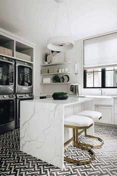 a kitchen with black and white tile flooring