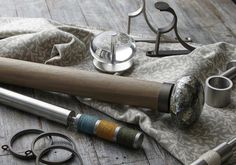 several different types of metal and wood items on a wooden surface with scissors, napkins, and other accessories