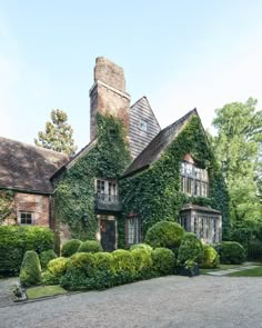 a large brick house covered in ivy