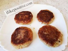 four hamburger patties on a white plate with a sign that says likepositive com