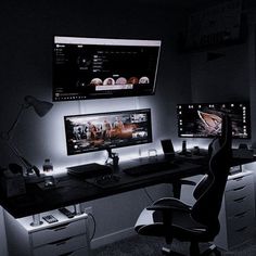 two computer monitors sitting on top of a desk