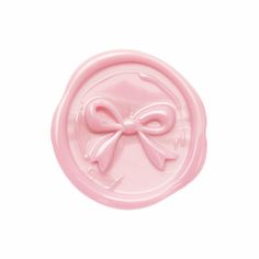 a pink wax stamp with a bow on it