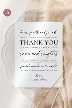 the wedding thank card is on top of a white plate with some string attached to it