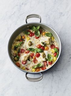 a pan filled with vegetables on top of a white counter