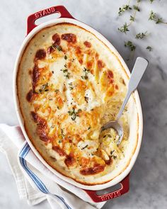 a casserole dish with cheese and herbs