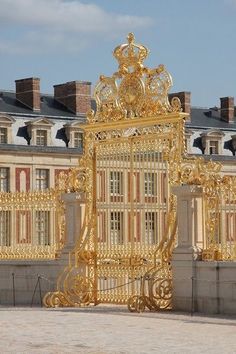 an ornate gold gate in front of a building