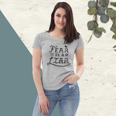 The women's Fear is a Liar fitted tee is a must-have. It's high-quality, super comfortable, and has form-fitting qualities. Best of all, it's made of 100% organic ring-spun combed cotton, making it an eco-friendly choice! * 100% organic ring-spun combed cotton * Fabric weight: 4.57 oz/yd² (155 g/m²) * Single jersey * Set-in sleeves * 1×1 rib at collar * Narrow double-needle topstitch on the sleeves and bottom hems * Self-fabric neck tape (inside, back of the neck) * Blank product sourced from Bangladesh This product is made especially for you as soon as you place an order, which is why it takes us a bit longer to deliver it to you. Making products on demand instead of in bulk helps reduce overproduction, so thank you for making thoughtful purchasing decisions! Basic Fitted Gray T-shirt, Fitted Gray Cotton T-shirt, Fitted Basic Pre-shrunk T-shirt, Fitted Gray T-shirt For Fall, Fitted Gray T-shirt With Letter Print, Fitted Pre-shrunk T-shirt For Everyday Wear, Fitted Gray Graphic Tee, Fitted Short Sleeve T-shirt For Fall, Fitted Basic Gray T-shirt