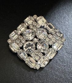 "Stunning vintage pin perfect for the holidays!   It is silver tone set with bright clear crystal stones. It measures 2.25\" x 2.25\".  It is in excellent condition." Vintage Crystal Brooches For Anniversary, Silver Jeweled Brooches For Formal Occasions, Formal Silver Jeweled Brooches, Silver Rhinestone Brooches For Anniversary, Vintage Crystal Brooch With Bling, Silver Crystal Brooch Pin, Silver Crystal Brooches For Anniversary, Silver Crystal Brooch For Anniversary, Silver Crystal Anniversary Brooches