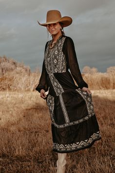 This maxi dress is perfect for a special occasion. Crafted from a woven fabric with elegant embroidery, it has a comfortable elastic waist, sheer long sleeves, and is fully lined for comfort. This timeless piece is sure to make a statement. 100% Polyester. Embroidered Western Dresses, Cowgirl Long Dress, Long Sleeve Western Dress, Western Boho Dress Outfit, Long Dress And Cowboy Boots, Montana Wedding Guest Outfit, Long Dress With Cowboy Boots, Cowboy Party Outfit, Western Wedding Outfits Guest