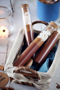 three candles in a basket on a table