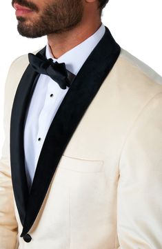 Bubbly Champaigne inspires the smart ivory hue of a dinner jacket framed in black-satin lapels with a fabric-wrapped button cinching the formal look. One-button closure Shawl collar Nonfunctional four-button cuffs Chest welt pocket; front slant pockets Back vent Lined 100% polyester Machine wash, line dry Imported Ivory Tuxedo Wedding, Groom Wearing White, Groomsman Outfits, White Dinner Jacket, Ivory Tuxedo, Groomsmen Outfits, Dinner Jacket, White Suit, Tuxedo Wedding