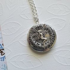 Fairy Gateway Locket Necklace ☻Locket ~ Round Silver ~ With Magical Fairy ~ See Photos for size comparison against American quarter Chain: ~ Silver Plated YOU CHOOSE YOUR CHAIN LENGTH during checkout ☻More Lockets Here: https://www.etsy.com/shop/FashionCrashJewelry/search?search_query=lockets&order=date_desc&view_type=gallery&ref=shop_search ☻Link to The ENTIRE SHOP: https://www.etsy.com/shop/FashionCrashJewelry?ref=shopsection_shophome_leftnav&ga_search_query=crystal%2Bnecklace Silver Fairy Jewelry For Festivals, Silver Fairy Style Jewelry For Festival, Fairy Style Silver Jewelry For Festival, Fairy Style Adjustable Wedding Jewelry, Adjustable Silver Fairycore Jewelry, Handmade Silver Fairycore Jewelry, Handmade Adjustable Fairy Jewelry, Fairy Style Silver Jewelry For Gift, Fairy Style Adjustable Jewelry For Gifts