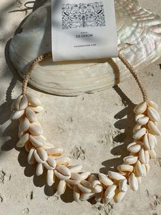 Introducing our new beach accessory: the OCEAN COWRIE SEASHELL CHOKER NECKLACE. Crafted with natural shells sourced, this statement piece beautifully captures the essence of the sea. Each shell is carefully combined to create a captivating and unique representation of oceanic beauty. Perfect for beach outfits, honeymoons, cruises, or resort wear, this choker necklace is a versatile addition to your wardrobe. What sets it apart is our commitment to sustainability and our dedication to working dir Seashell Choker, Beach Outfits, Honeymoons, Beach Accessories, Cruises, Resort Wear, Beach Outfit, The Ocean, Sea Shells