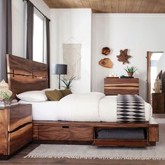 a bed sitting in a bedroom next to a dresser with drawers on top of it