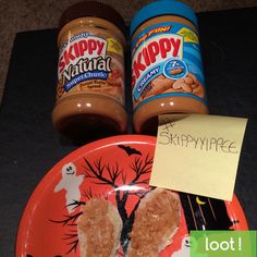 two peanut butter and jelly sandwiches on a plate with a note saying skippypee