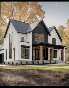 a white and black house with lots of windows