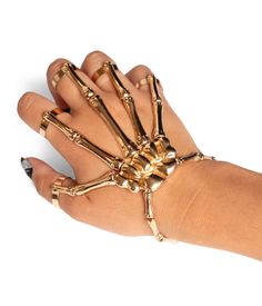 All that grabs is gold. Your hand is your most precious asset that you always forget to thank – but that’s about to change with the Gold Skeleton Finger Bracelet. Match your skeleton jumpsuit, bodysuit or dress with this powerful accessory and forget your phalanges no more. Ribcage Fashion, Adjustable Gold Jewelry For Halloween, Gold Metal Jewelry For Costume Party, Gold Halloween Party Jewelry, Gold Jewelry For Costume Party, Skeleton Jumpsuit, Golden Halloween, Skeleton Outfit, Skeleton Hand Bracelet