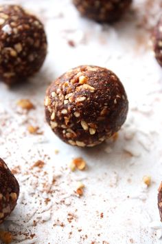 several chocolate balls with nuts on top of them