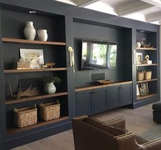 a living room filled with furniture and lots of shelves