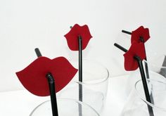 two glasses with straws sticking out of them, one is red and the other is black