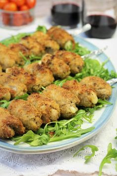 some food is on a plate with lettuce and tomatoes in the back ground