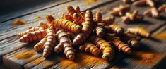 there are many different colored carrots on the wooden table with yellow and orange powder