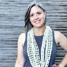 a woman wearing a white crochet scarf