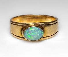 Mid Century c1960s Very nice, low profile 14k band featuring a 1 ct bezel set Australian Precious Opal. Nice fire and flash. Very pretty ring. 4g 14k solid yellow gold Hallmarked Australian Precious Opal 1ct+ S 5.25 US Fine vintage condition Formal 14k Gold Opal Ring With Bezel Setting, Classic Yellow Gold Opal Ring With Bezel Setting, Antique Opal Rings Collectible, Antique Gold Opal Ring Collectible, Vintage Gold Opal Cabochon Ring, Antique 14k Gold Hallmarked Opal Ring, Vintage Yellow Gold Opal Cabochon Ring, Australian Opal Ring, Ring Inspiration