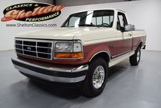 a red and white truck parked in a garage