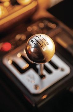 a close up view of a car's gear shift knob with the number plate and numbers on it