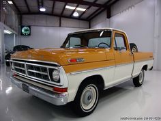 an orange and white truck parked in a garage