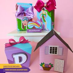 two boxes with different designs on them and one has a doll house in the middle