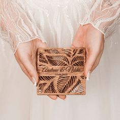 a person holding a wooden box in their hands with the words celebration and wishes engraved on it