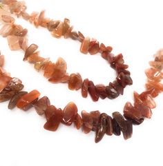 two necklaces with different shapes and colors on them, one is made out of agate